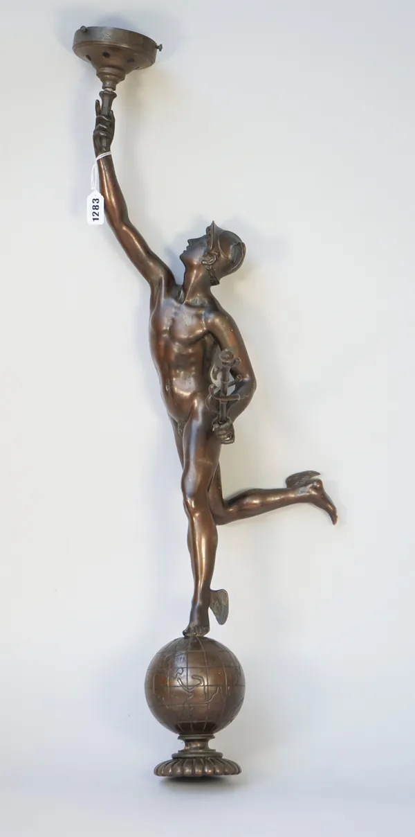 A bronze figural table lamp, depicting Mercury on top of a globe holding a flaming torch (lacking base), 79cm high.