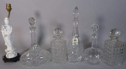A group of ten assorted 20th century cut glass decanters and two blanc de chine style figures made into lamps, (12).