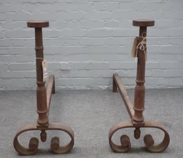 A pair of Georgian style cast iron andirons, with flat circular finials and tapering columns on scroll feet, 73cm high, (2).