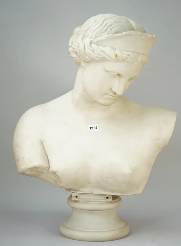 A modern composite bust depicting Aphrodite, on a turned socle, 69cm high.