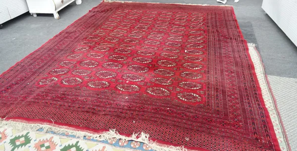 An Indian Bokhara carpet, red field, 358cm x 275cm.