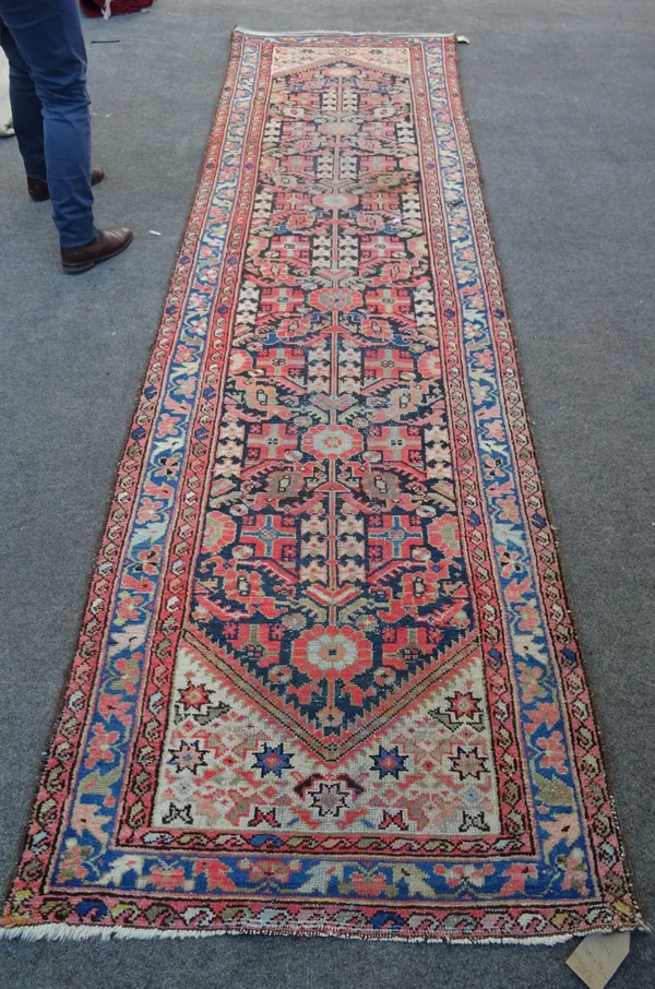 A Mahal runner, Persian, the black field with an all over herate design, a narrow indigo trailing flower and leaf border, 360cm x 94cm.