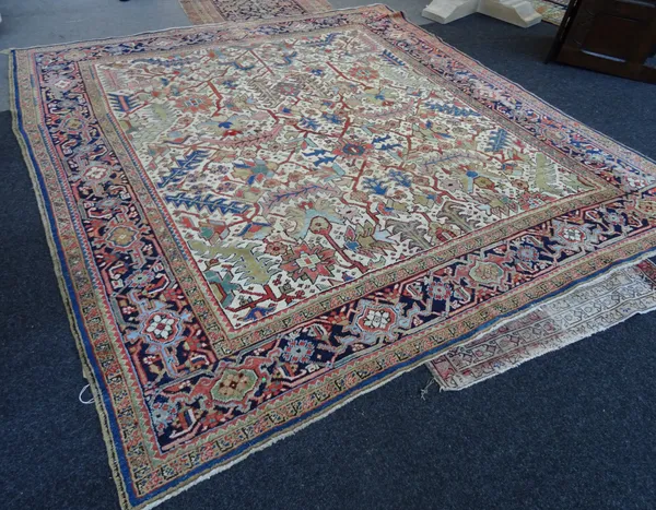 A Mahal carpet, Persian, the ivory field with all over design of vines with an indigo palmette and vine border, 280cm x 257cm.