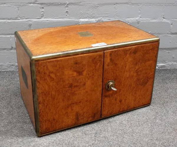 A Victorian brass bound oak table cabinet, the pair of doors enclosing three drawers, 48cm wide x 30cm high.