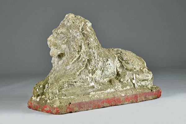 A reconstituted stone figure of a recumbant lion on a rectangular base, 74cm wide x 50cm high.