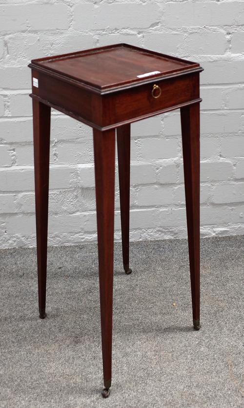 A George III mahogany kettle stand, the square top with slide on square tapering supports, on leather castors, 23cm wide x 67cm high.
