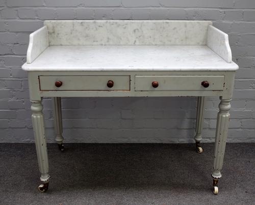 A William IV later painted marble top washstand, with pair of frieze drawers, on reeded supports, 107cm wide x 91cm high.