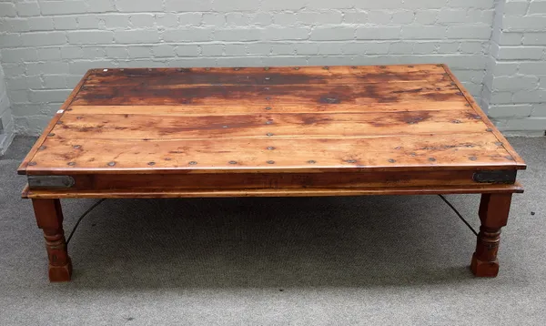 A 19th century Indian iron bound coffee table with plank top on turned supports, 104cm wide x 169cm long.