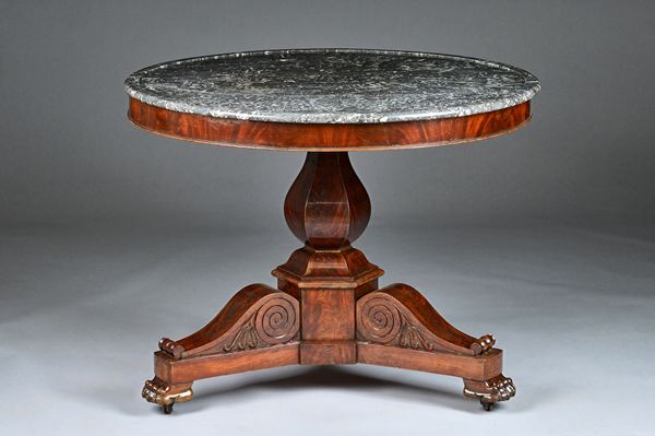 An early 19th century French gueridon, the dished circular marble top on a mahogany hexagonal baluster column and three paw feet, 98cm diameter x 68cm