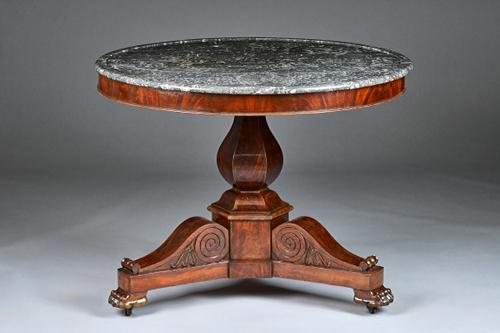 An early 19th century French gueridon, the dished circular marble top on a mahogany hexagonal baluster column and three paw feet, 98cm diameter x 68cm