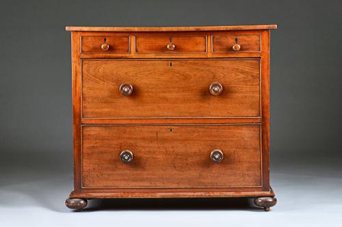 A 19th century mahogany chest of drawers, the shaped top over three small frieze drawers and two deep drawers on bun feet, 92cm wide.