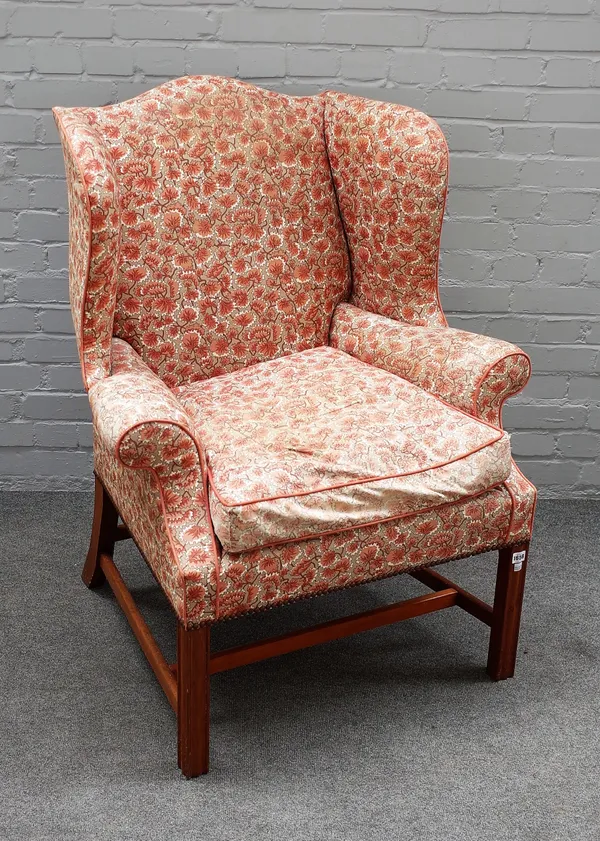 A George III style wingback armchair, on block mahogany supports, 88cm wide x 110cm high.