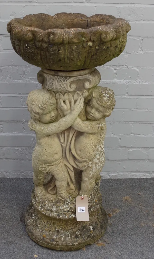 A reconstituted stone bird bath, the floral moulded column on a trio of cherubs, 50cm diameter x 95cm high.