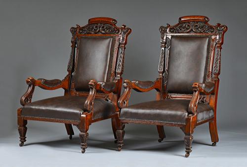 A pair of Victorian oak framed open armchairs, with carved serpent crest and arm supports, on tapering square supports, 74cm wide x 120cm high (2).