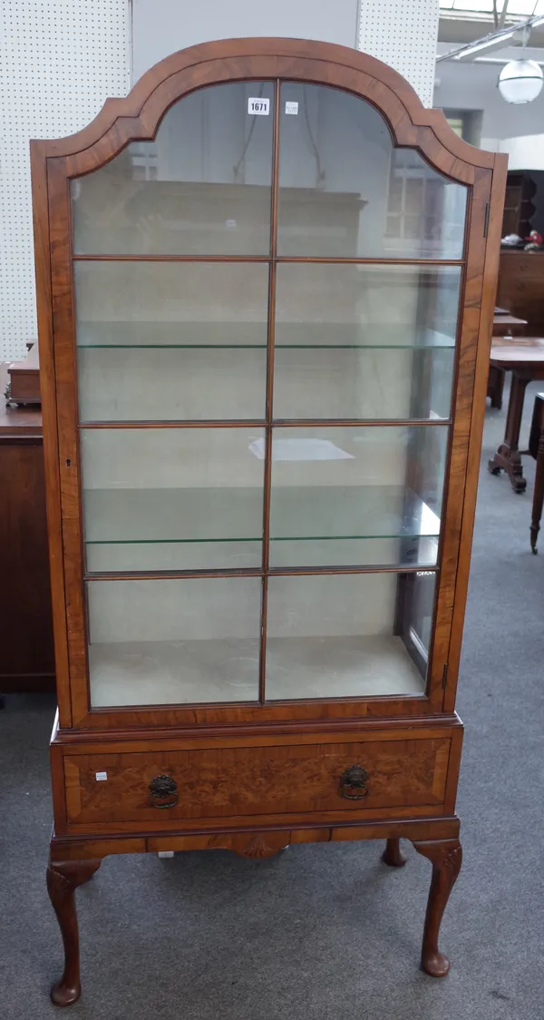 A mid-20th century Queen Anne revival figured walnut dome top display cabinet, with single drawer base, on cabriole supports, 80cm wide x 173cm high.