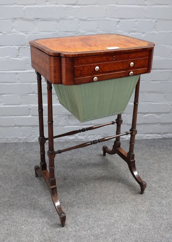 A Regency amboyna and amaranth work table, the crossbanded hinged top over silk slide drawer, on twin ring turned supports, joined by stretchers, 69cm