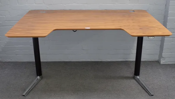 A 20th century walnut and chrome height adjustable desk with concave top, 161cm wide x 100cm deep.