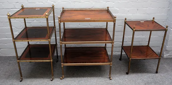 Three assorted brass mounted three tier etageres, on turned supports, the larger 52m wide x 71cm high, (3).