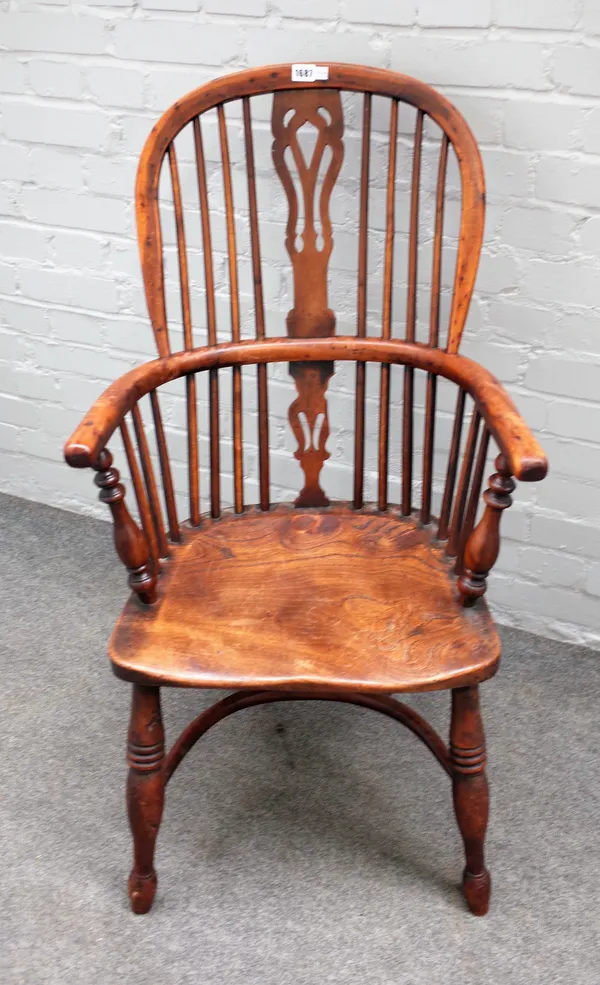 A 19th century yew and elm Windsor chair on turned supports united by crinoline stretcher, 57cm wide x 102cm high.