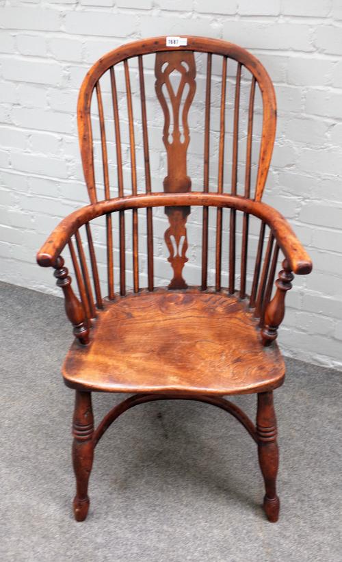 A 19th century yew and elm Windsor chair on turned supports united by crinoline stretcher, 57cm wide x 102cm high.