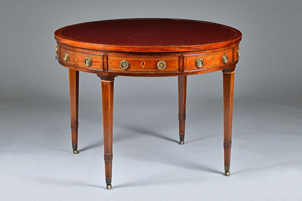 A George III mahogany drum table with inset leather top over four frieze drawers on turned supports, 98cm wide x 73cm high.