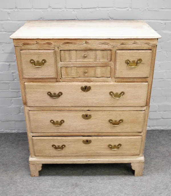 An early 18th century bleached oak two part chest with four short drawers over three long drawers on bracket feet, 82cm wide x 99cm high.