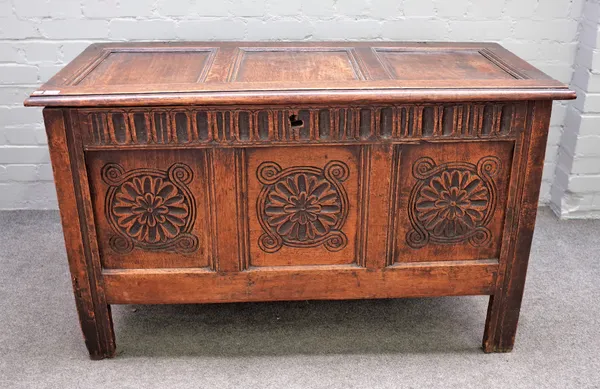 A 17th century oak coffer with triple panel lid over carved triple panel front on stile feet, 123cm wide x 73cm high.