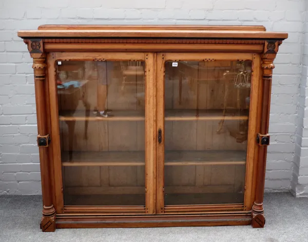 A Victorian Gothic inlaid oak glazed two door bookcase with turned columns, 159cm wide x 133cm high, adapted.