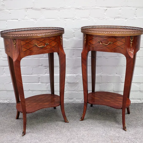 A pair of French marquetry inlaid kingwood oval bedside tables with single frieze drawer and platform undertier, 42cm wide x 69cm high.