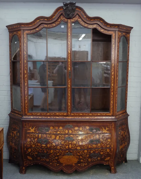 An early 19th century Dutch floral marquetry display cabinet / chest, the bonnet top over pair of glazed doors and bombe three drawer base, 191cm wide