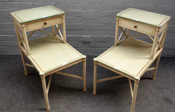 A pair of 20th century cream painted two tier night stands, on reeded supports, 58cm wide x 68cm high, (2).