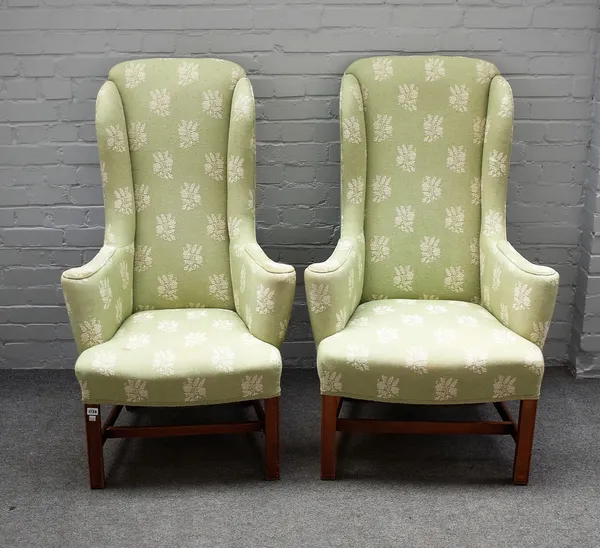 A pair of early 18th century style high wingback armchairs, on block mahogany supports, 70cm wide x 122cm high.