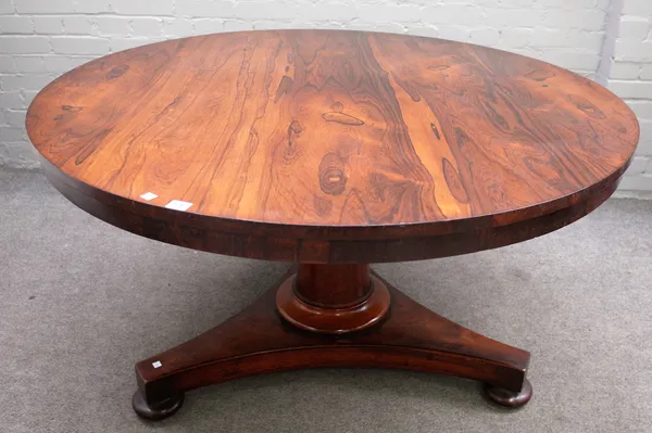 A William IV rosewood centre table, the circular snap top on turned column and triangular platform, 130cm diameter x 73cm high.