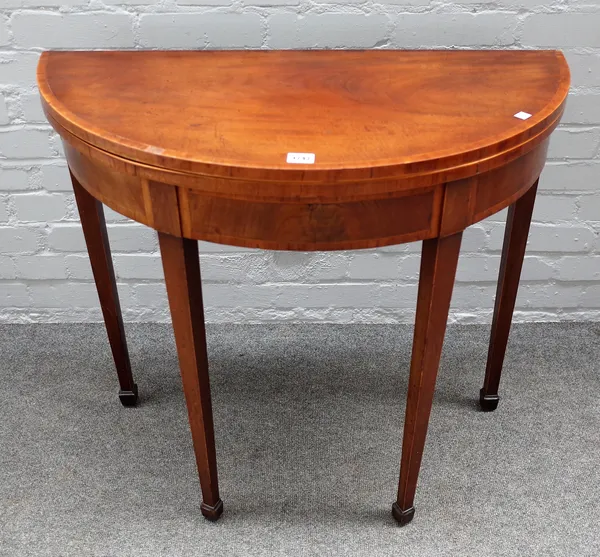 A George III mahogany semi elliptic card table on tapering square supports, 83cm wide x 74cm high.