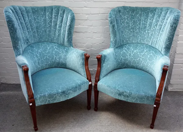 A pair of blue patterned upholstered shell back armchairs, on tapering reeded square supports, 72cm wide x 115cm high.