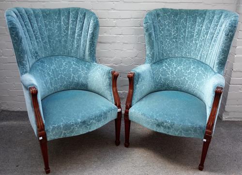 A pair of blue patterned upholstered shell back armchairs, on tapering reeded square supports, 72cm wide x 115cm high.