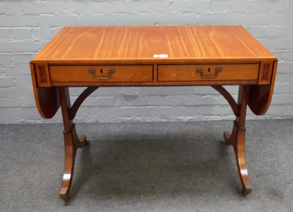 William Tillman; a Regency style satinwood two drawer sofa table, on downswept supports, 95cm wide x 74cm high.