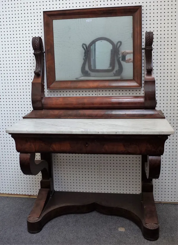 A French Empire mahogany dressing table, the scroll mounted mirror over marble top and frieze drawer, on scroll supports, 101cm wide x 155cm high.