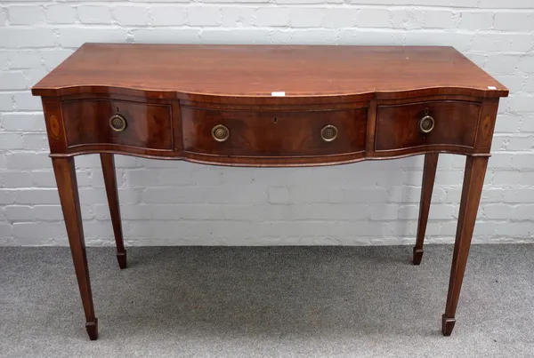 A George III style inlaid mahogany serpentine three drawer serving table on tapering square supports, 123cm wide x 87cm high.