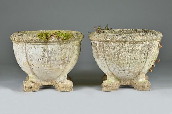 A pair of circular reconstituted stone jardinieres, each on four lion's paw feet, 60cm diameter x 50cm high.