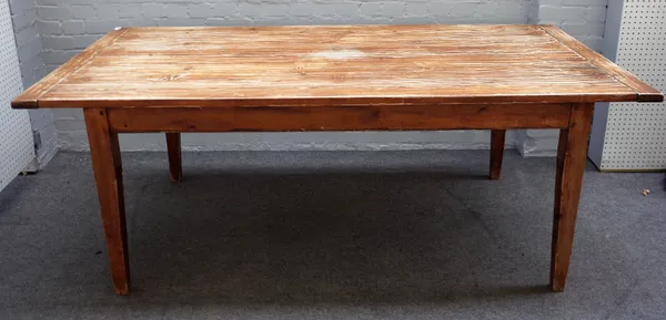 A stained pine kitchen table, the pegged biscuit joint plank top on tapering square supports, 102cm wide x 203cm long.