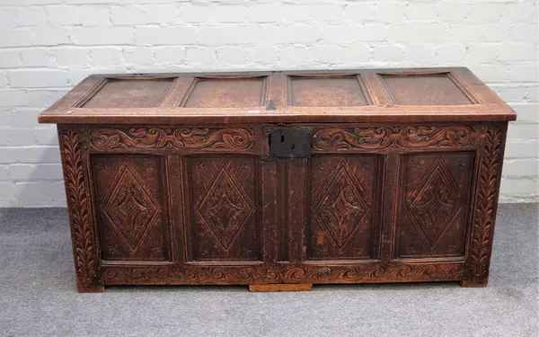 A 17th century oak coffer with four panel lid over four panel front, 139cm wide x 59cm high.