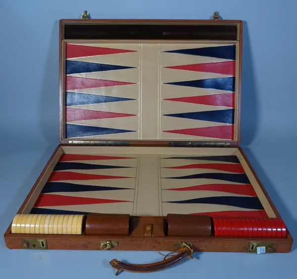 A 20th century brown leather cased travelling Backgammon set, 67cm wide.