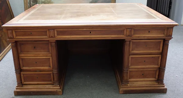 An early 20th century French walnut free standing writing desk with nine drawers about the knee flanked by fluted columns, 160cm wide x 120cm diameter