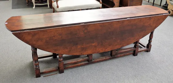 A large 19th century oak double action gateleg wake table on turned supports, 260cm wide x 77cm high.