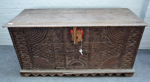 A 17th century continental oak coffer with plank top over carved front on diamond shaped plinth base, 144cm wide x 72cm high. 5420