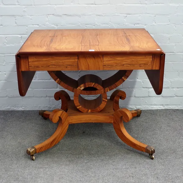 A Regency style hardwood sofa table with pair frieze drawers on open column and four downswept supports, 88cm wide x 74cm high.