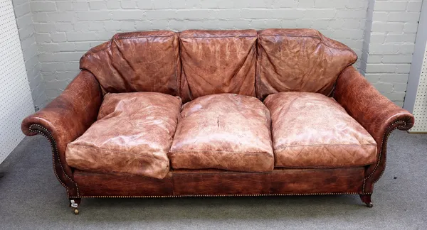 A studded brown leather sofa with outswept arms on splayed block supports, 197cm wide x 81cm high.