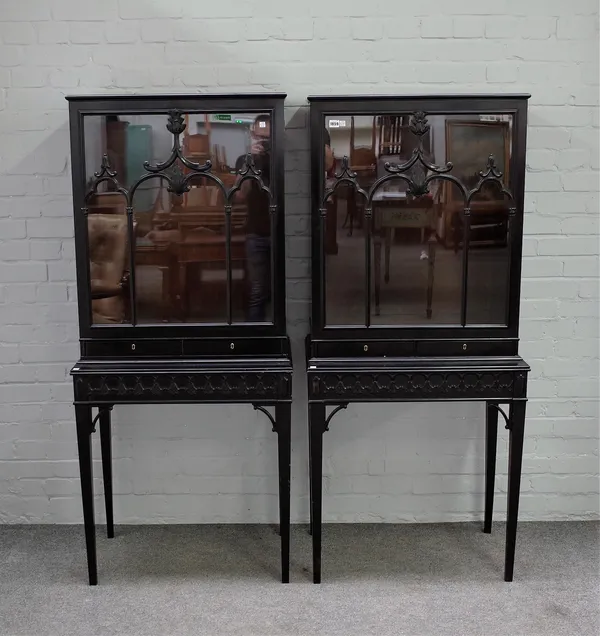 A pair of ebonised display cabinets, each with glazed doors over pair of drawers on tapering square supports, 72cm wide x 164cm high.