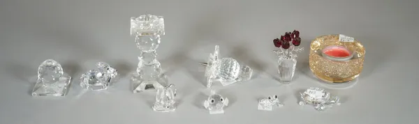 Swarovski; a group of eight figures comprising, a puffer fish, a candle, a lion, a pair of candlesticks, ballet shoes, a tree frog, a sea turtle and f